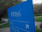 An employee walks past a signage board in the Infosys campus at the Electronics City IT district in Bangalore, February 28, 2012.