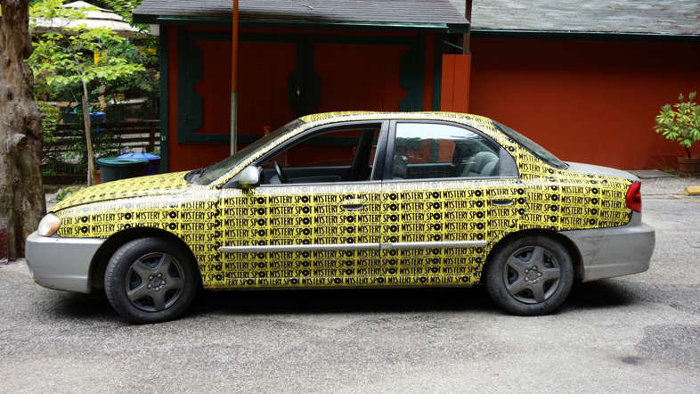 A car covered with bumper stickers in Santa Cruz, California USA.