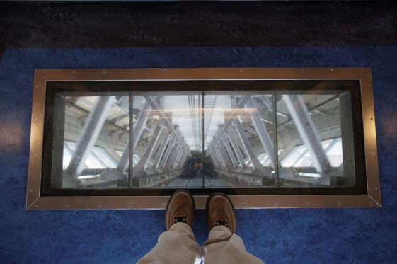 View through glass floor in elevator of Sky Tower, Auckland, New Zealand