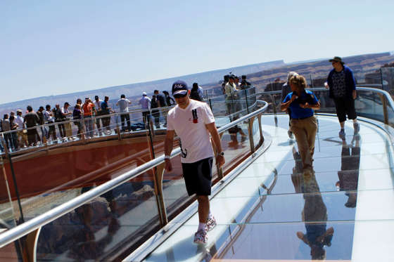Tourist walk along the Sky Walk over looking the Grand Canyon on the Hualapai Indian Reservation near Peach Springs, Arizona May 6, 2011. Joshua Lott/Reuters