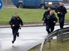 Members of the French gendarmerie intervention forces arrive at the scene of a hostage-taking at an industrial zone in Dammartin-en-Goele, northeast of Paris, January 9, 2015.