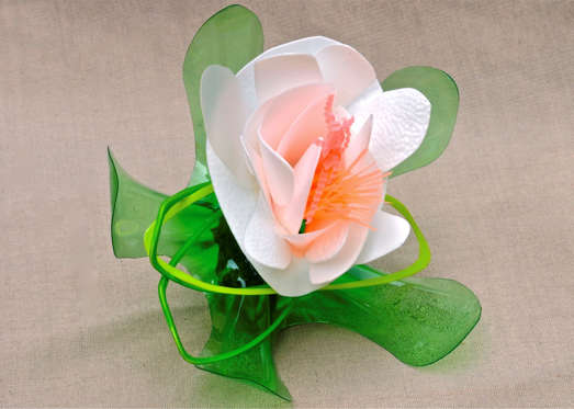 In this undated publicity image provided by Lauren Karnitz Studio, a White Glory with Leaves Corsage is shown in Knoxville, Tenn. Brides are choosing plastic, recycled flowers not only for cakes, but for bouquets, corsages and boutonnieres.  (AP Photo/Lauren Karnitz Studio, Bert Henry)