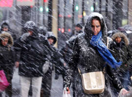 Pedestrians make their way through driving snow in midtown Manhattan in New York, Monday, Jan. 26, 2015. More than 35 million people along the Philadelphia-to-Boston corridor rushed to get home and settle in Monday as a fearsome storm swirled in with the potential of 1 to 3 feet of snow that could paralyze the Northeast for days.