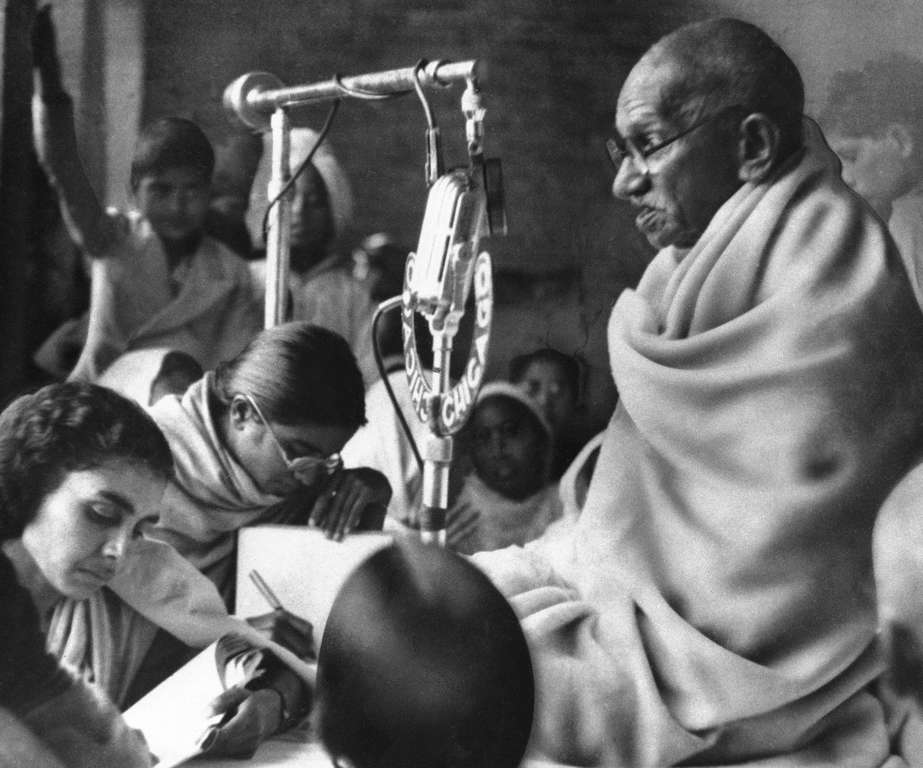 In this January 22, 1948 file photo, Mohandas K. Gandhi addresses people at a prayer meeting in New Delhi, during second day of his fast to force communal peace in India.