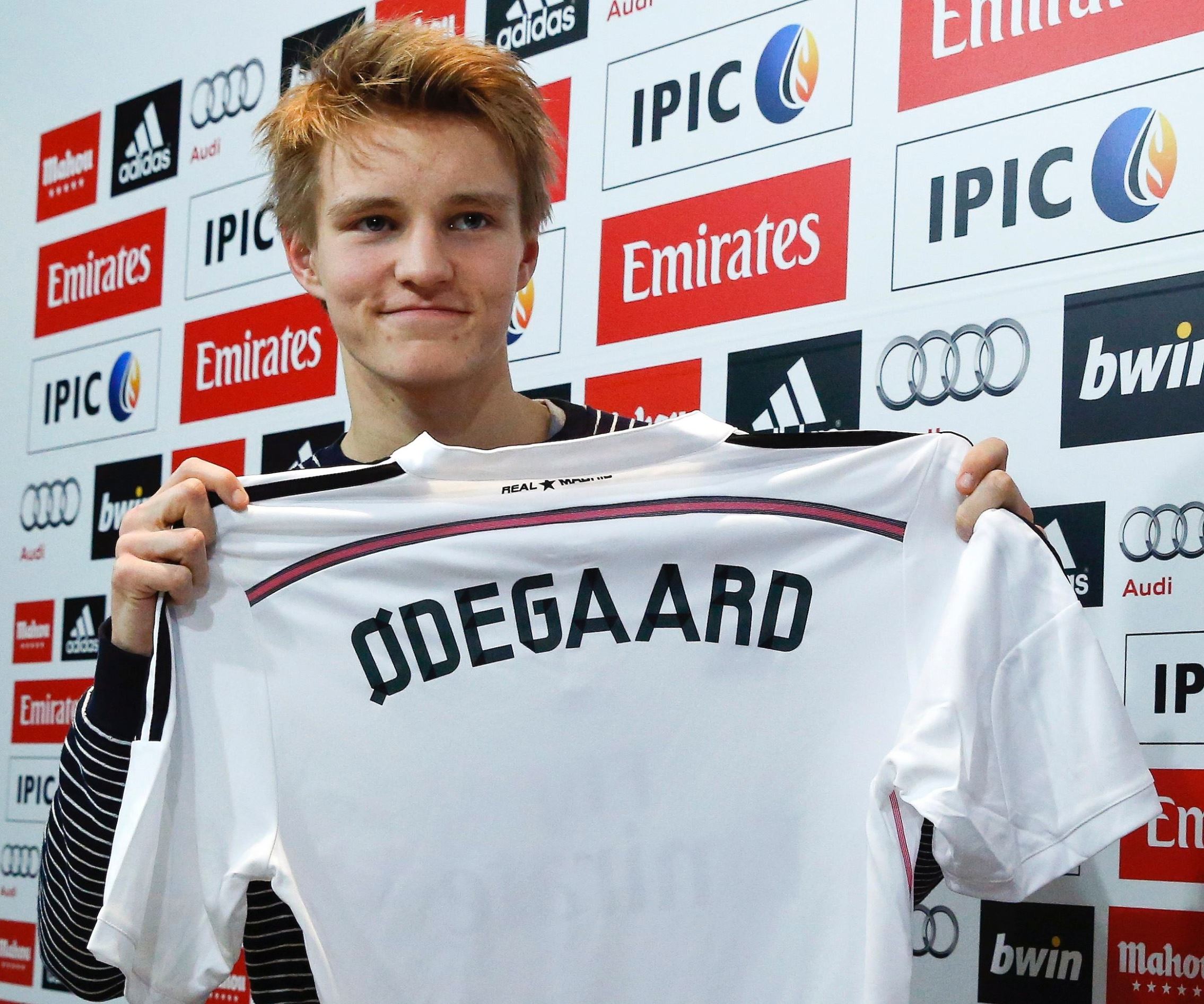 Real Madrid's new teenage signing Martin Odegaard from Norwegian club Stromsgodset holds up his jersey during his presentation at the Valdebebas training grounds in Madrid, January 22, 2015.