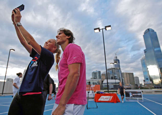 Denmark's Caroline Wozniacki (L)  takes a selfie with Spain's Rafael Nadal as they participate in a tennis promotional event in Melbourne January 16, 2015.