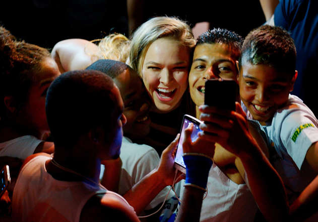 UFC Women's Bantamweight Champion Ronda Rousey of the United States takes photos with fans during the the UFC 189 World Media Tour Launch press conference at Maracanazinho, at Maracanazinho on March 20, 2015 in Rio de Janeiro, Brazil.