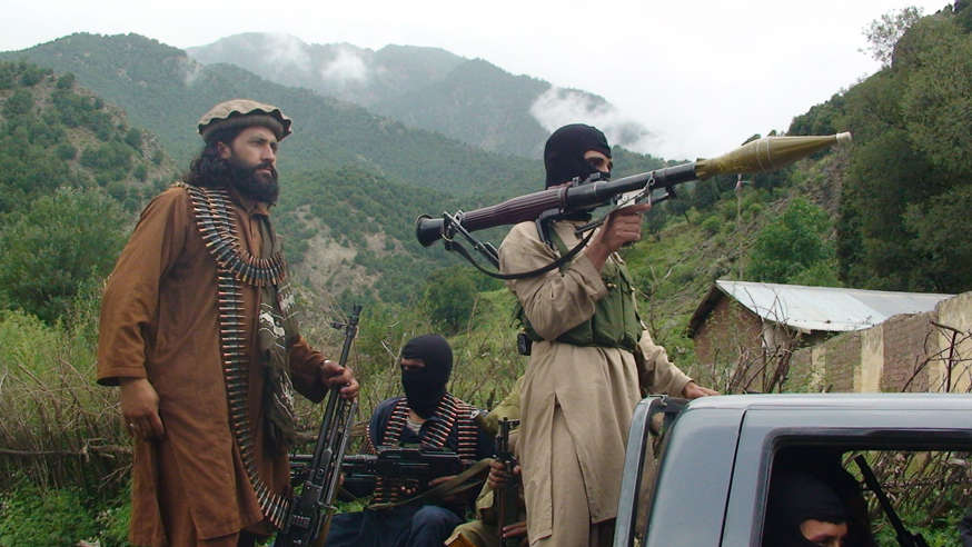 In this photo taken Aug. 5, 2012, Pakistani Taliban patrol in their stronghold of Shawal in Pakistani tribal region of South Waziristan.