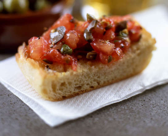 One of the most famous dishes of Spain, pan con tomate literally means bread with tomato. Tomato pulp or small pieces of tomato seasoned with olive oil are served on slices of bread.