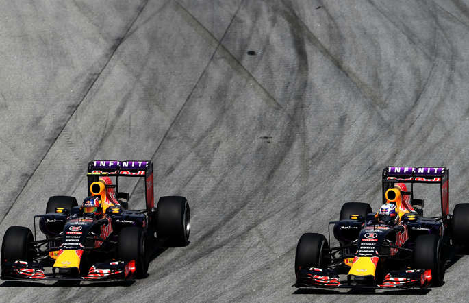 Daniel Ricciardo of Australia and Infiniti Red Bull Racing drives next to Daniil Kvyat