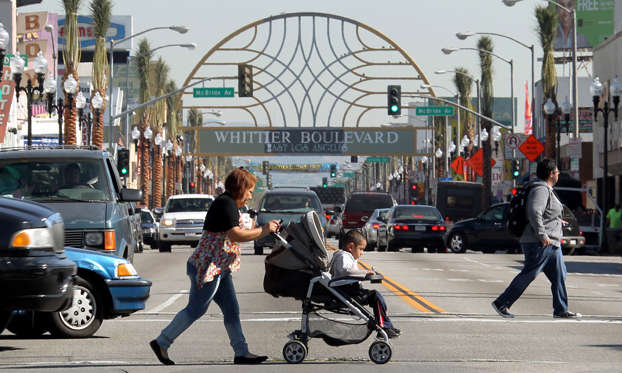 People walk by Whittier Boulevard in East Los Angeles.  Reed Saxon/AP Photo