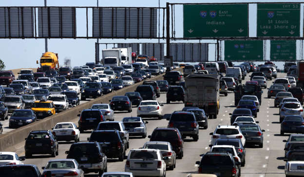 FILE - In this May 24, 2013 file photo, traffic begins to thicken as motorists getting an early jump to Memorial Day destinations in Indiana and Michigan travel an interstate freeway through Chicago. Auto club AAA on Friday, May 16, 2014 said it expects a total of 36.1 million people to travel 50 miles or more this Memorial Day Weekend. If that estimate holds true, it would be the largest amount of people traveling during the holiday weekend since 2005. (AP Photo/Charles Rex Arbogast, File)
