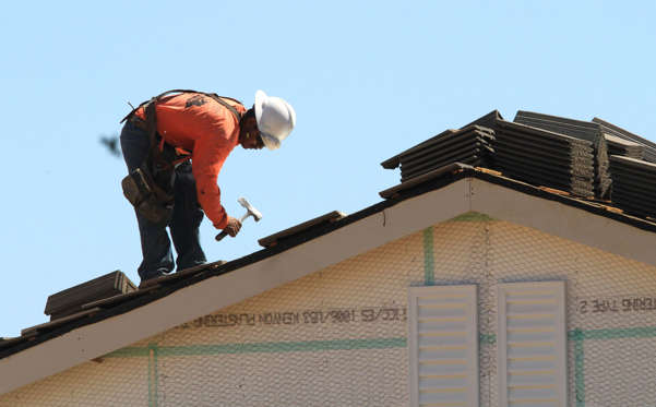 In this photo taken Thursday, Sept. 16, 2010, a worker is seen on the roof of a new home under construction in Elk Grove, Calif.  Rich Pedroncelli/AP