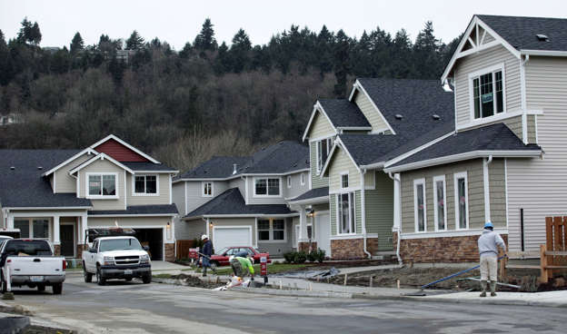 Workers put in a sidewalk in a development of new homes for sale Thursday, Jan. 29, 2009, by Polygon Northwest Co. in Kent, Wash. Ted S. Warren/AP