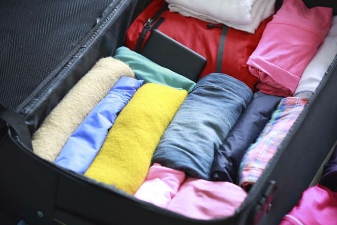 Clothes rolled up in suitcase