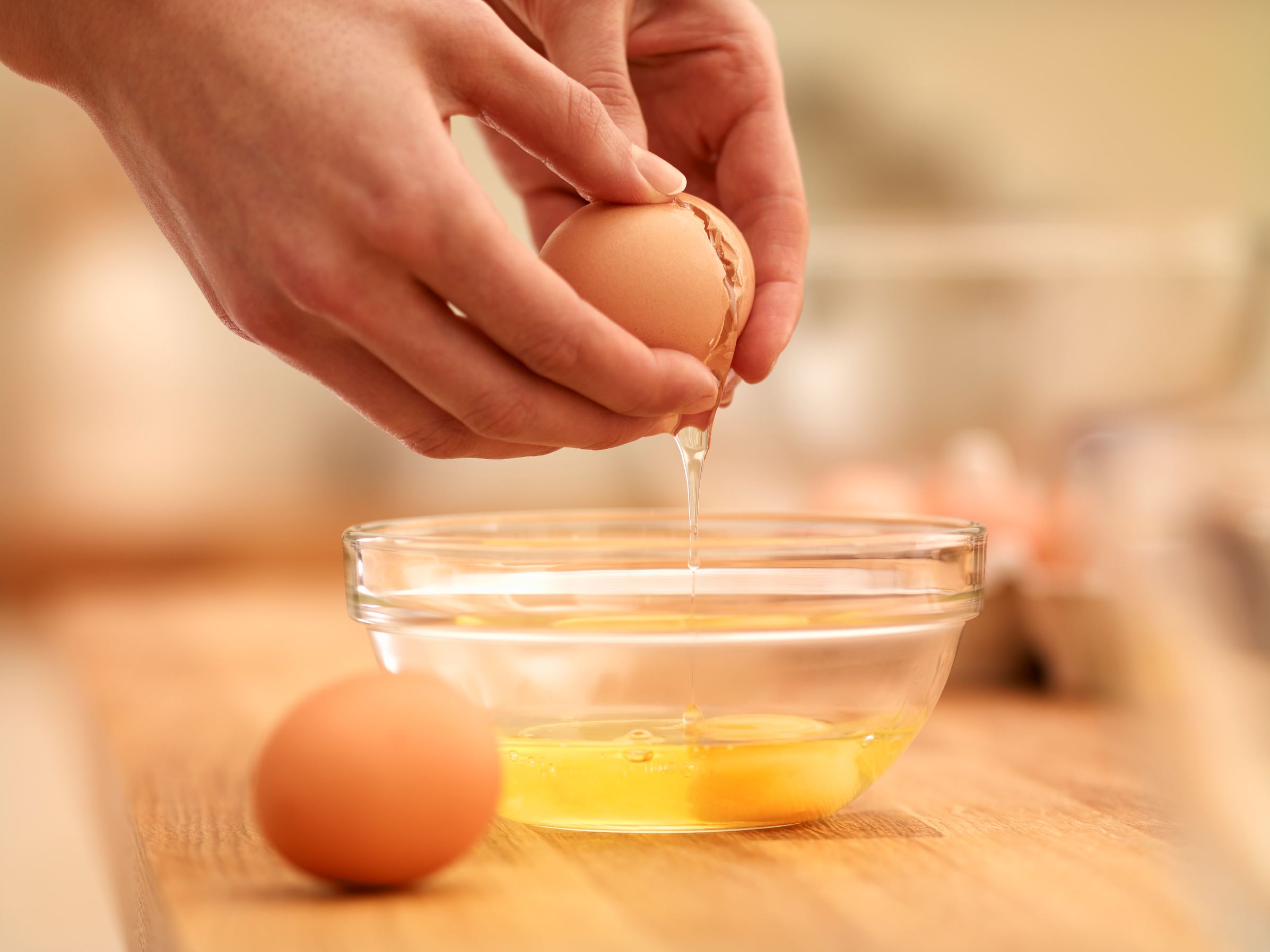 Woman cracking egg