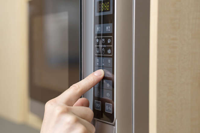 Person using microwave