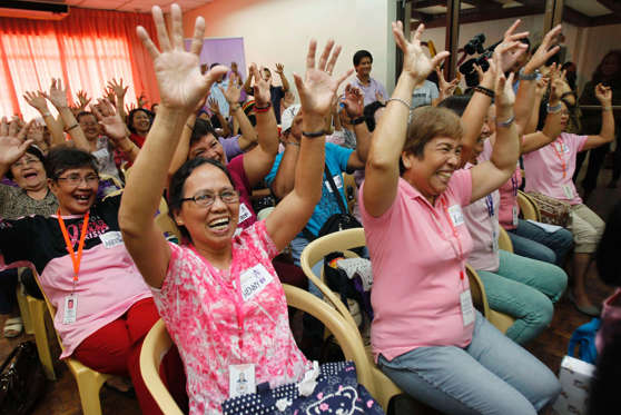 Cancer patients go through laughter yoga treatment, a breathing exercise that stimulates voluntary laughing at Jose Reyes Memorial Medical Center in Manila September 6, 2013. Practitioners of laughter yoga claim it can help relieve stress, strengthen the immune system and promote a positive outlook in life.