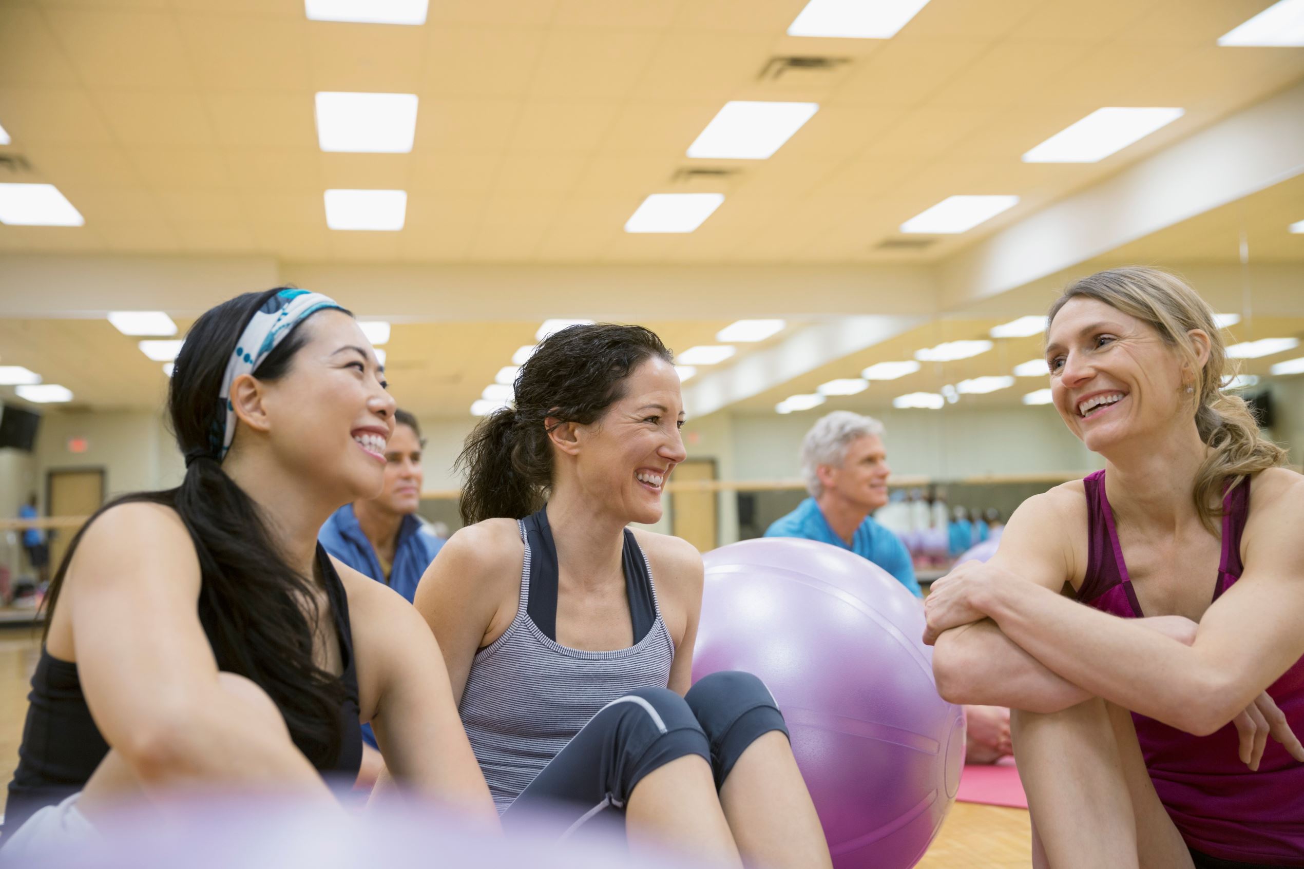 Smiling women talking in exercise class
