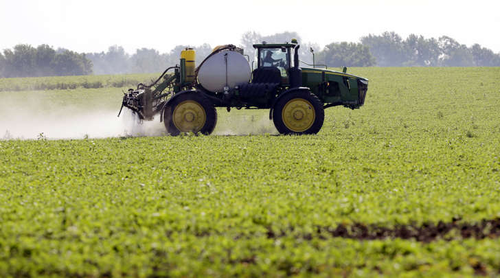 This July 11, 2013, file photo shows Blake Beckett of West Central Cooperative as he sprays a soybean field, in Granger, Iowa.