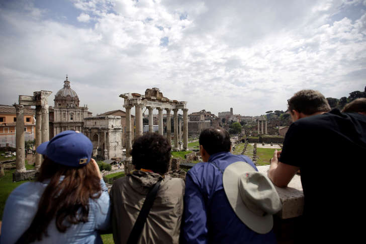 Tourists visit the ancient Roman forum in Rome, April 17, 2015.