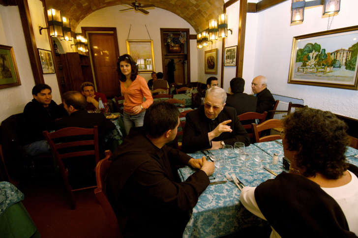 Customers including clergymen wait for their meal at 'Ristorante da Roberto's al Passetto di Borgo' in Borgo Pio, the area near the Vatican in Rome, Italy, April 23, 2005.