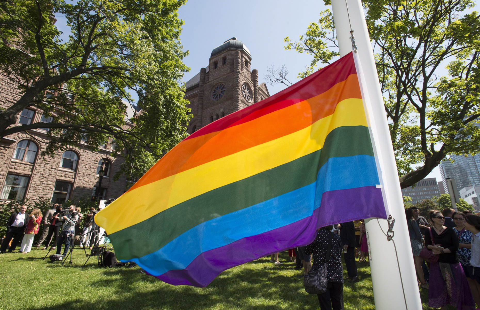 The Pride flag hangs from the flagpole in front of the Ontario legislature at Qu...