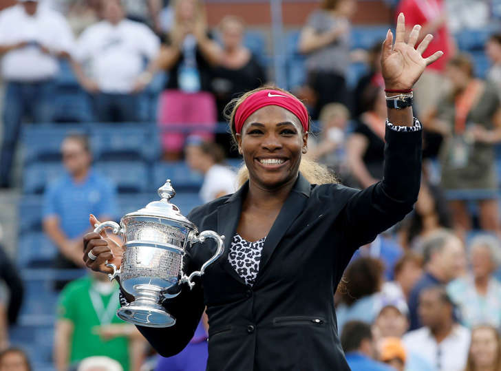 Serena Williams of the U.S. holds her trophy and waves to the crowd after defeating Caroline Wozniacki of Denmark in their women's singles finals match at the 2014 U.S. Open tennis tournament in New York City on Sunday.