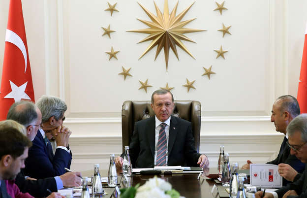 ​In this photo released by the Turkish Presidency Press Office, Turkish President Recep Tayyip Erdogan, center, and U.S. Secretary of State John Kerry, third left, speak during a meeting in Ankara, Turkey, Sept. 12, 2014.