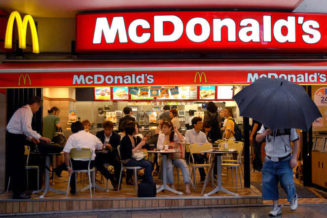 Customers are seen sitting at tables at a McDonald and apos;s restaurant in Tokyo, Tuesday, 18 July, 2006.