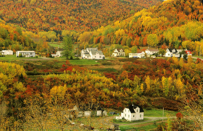 Gaspé Peninsula, Quebec, Canada - Barrett & MacKay/All Canada The village of Petit-Riviere-au-Renard in Fall, Gaspé, Quebec, Canada with it's leaves bursting with red and gold, makes for an idyllic location for a romantic holiday.