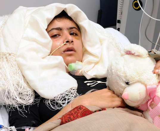 FILE - In this undated file photo provided by the University Hospitals Birmingham NHS Foundation Trust on Friday, Oct. 19, 2012, then 15-year old Pakistani shooting victim Malala Yousufzai lies on a bad as she recovers in Queen Elizabeth Hospital in Birmingham, England. European lawmakers have awarded their top human rights prize to Pakistani schoolgirl Malala Yousafzai, who survived a Taliban assassination attempt last year. The European Parliament announced Thursday, Oct, 10, 2013, that 16-year-old Malala won the 50,000 euro ($65,000) Sakharov Award.