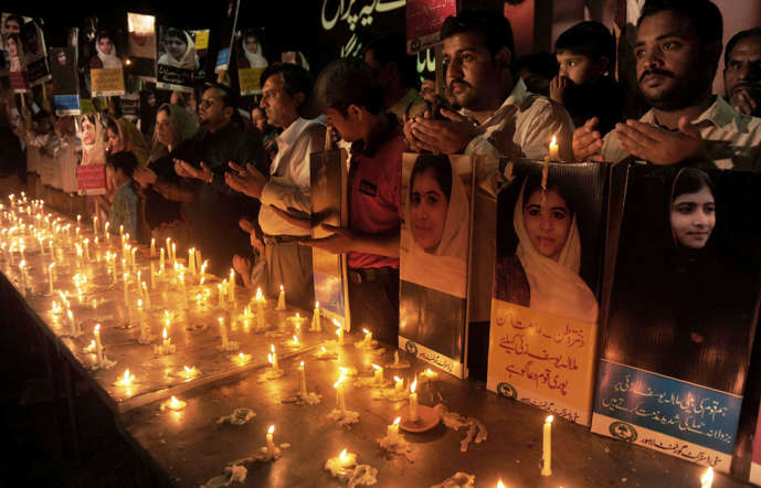 Pakistani people pray for the early recovery of child activist Malala Yousafzai, who was shot in the head in a Taliban assassination attempt, as they pay tribute in Lahore on October 12, 2012. Pakistanis at mosques across the country prayed Friday for the recovery of a schoolgirl shot in the head by the Taliban as doctors said the next two days were critical.