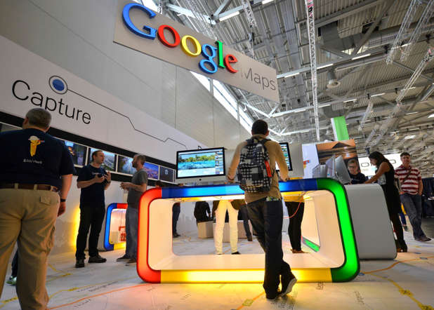 Visitors are testing Google maps products during the photo fair Photokina in Cologne, Germany, Thursday, Sept. 18, 2014. One of the largest fairs for imaging is open until Sept. 21, 2014.