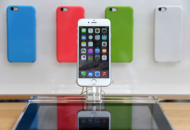 Apple Inc.'s iPhone 6 is displayed at the company's Omotesando store in Tokyo, Japan, on Friday, Sept. 19, 2014. Apple stores attracted long lines of shoppers for the debut of the latest iPhones, indicating robust pent-up demand for bigger-screen smartphones.