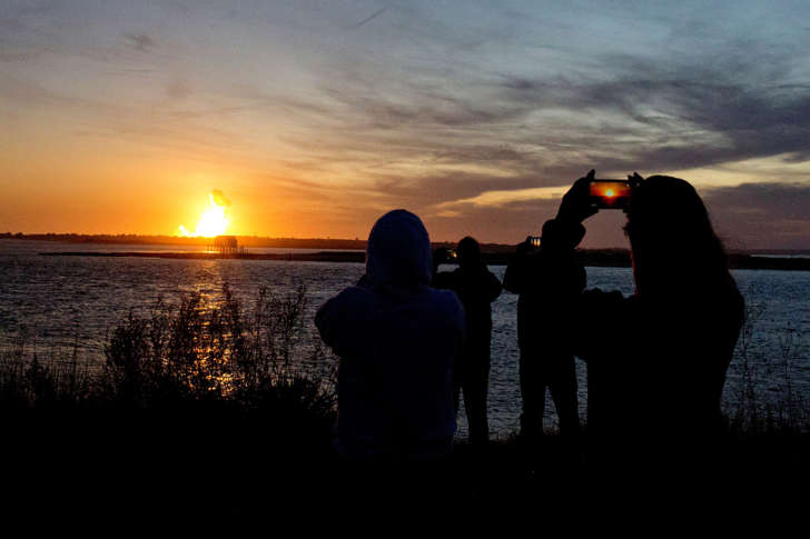 Spectators in Chincoteague, Va. watch the fireball from the explosion of the unmanned Orbital Sciences Corp.'s Antares rocket and Cygnus cargo capsule seconds after liftoff from Wallops Island, Va. on Tuesday, Oct. 28, 2014. No injuries were reported following the first catastrophic launch in NASA's commercial spaceflight effort.