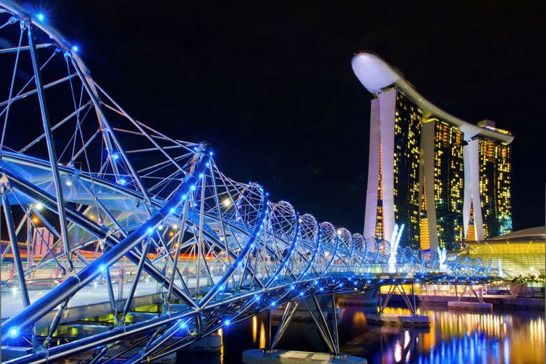 Glamour shot of Helix Bridge and Marina Bay Sands Casion Hotel at night, the icon of Singapore
