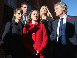 Don Maguire (R) and his daughters Emma (front left) and Kerry (front centre), the family of murdered teacher Ann Maguire, stand outside Leeds Crown Court.