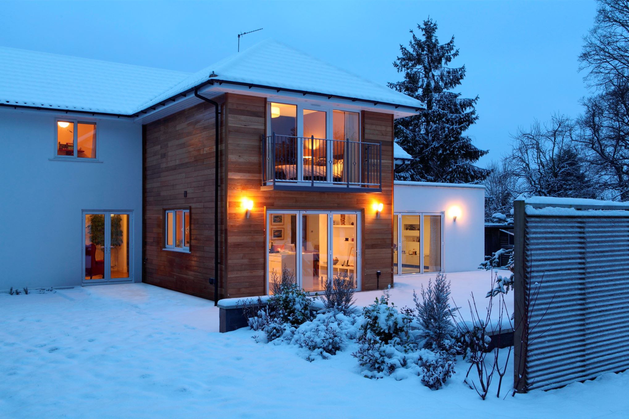 Illuminated family home in snow