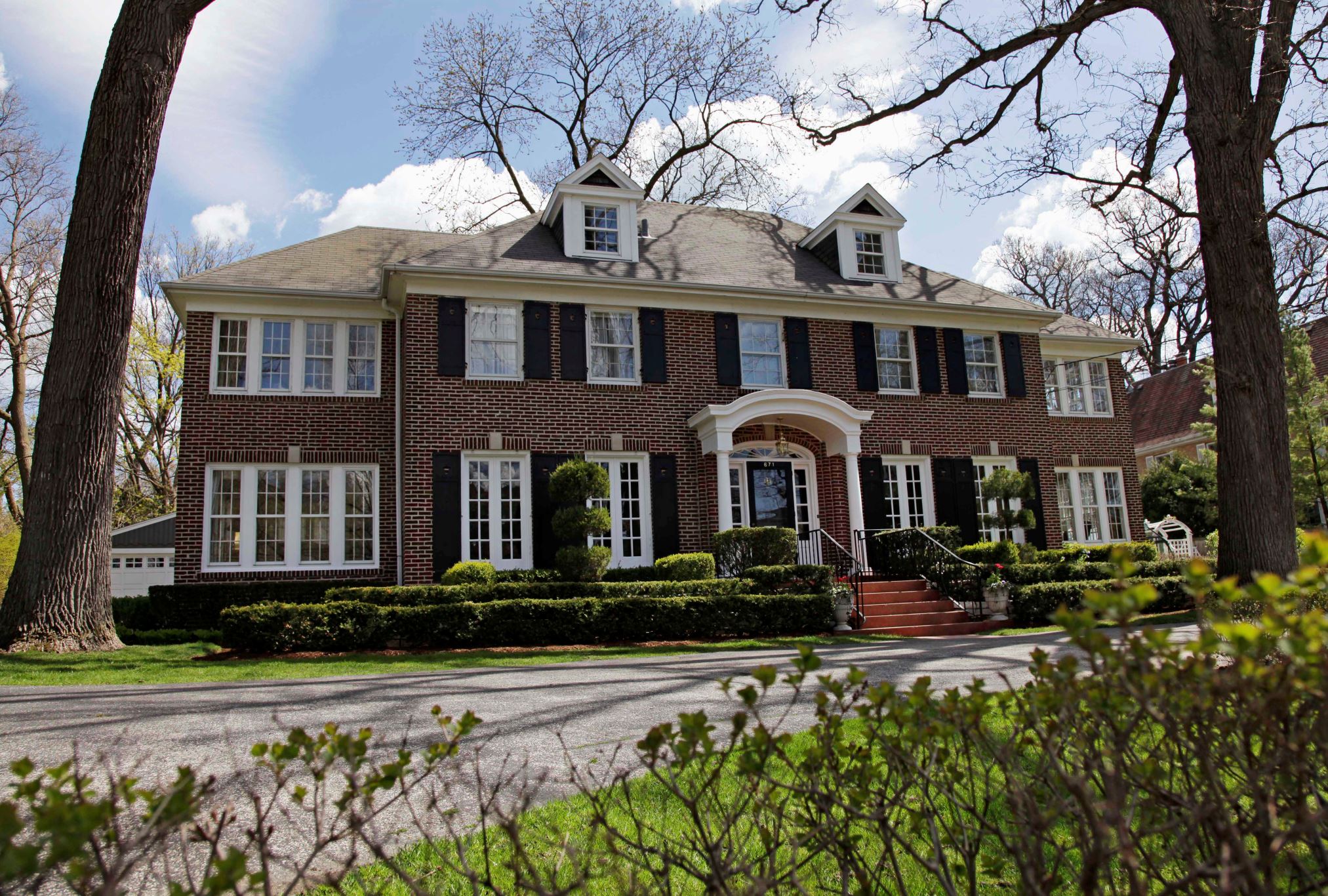 This 14-room brick house in Winnetka, Ill., seen May 6, 2011, and featured in the 1990 movie "Home Alone" has been put up for sale for $2.4 million. The family comedy featured a young Macaulay Culkin defending the house from intruders. The 4,250-square foot house sits on a half-acre lot about 20 miles north of Chicago. There are four bedrooms and it features the staircase that Culkin sledded down in the movie.