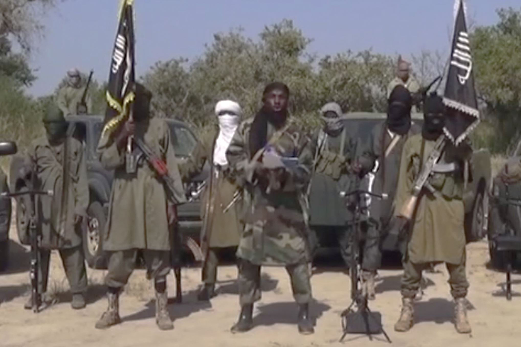 This Friday Oct. 31, 2014 image taken from video by Nigeria's Boko Haram terrorist network, the leader of Nigeria's Islamic extremist group Boko Haram, center, has denied agreeing to any cease-fire with the government and said Friday more than 200 kidnapped schoolgirls all have converted to Islam and been married off. (AP Photo)