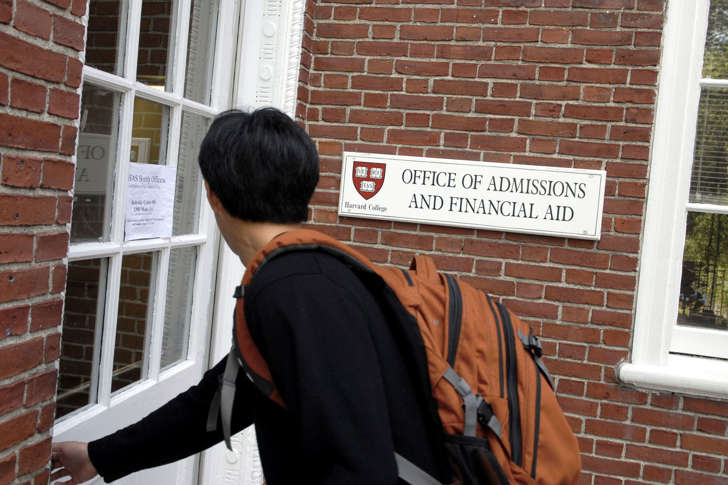 A freshman enters the Admissions Building at Harvard University in Cambridge, Massachusetts.  (Photo by Glen Cooper/Getty Images)