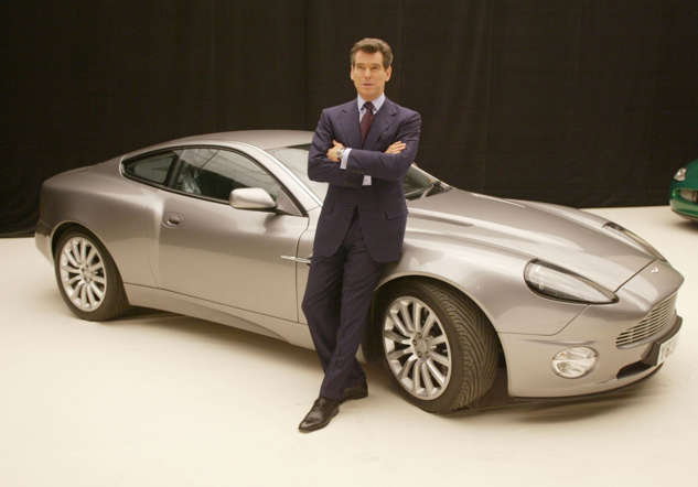 BUCKINGHAMSHIRE, ENGLAND - JANUARY 11: Actor Pierce Brosnan poses with an Aston Martin V12 Vanquish at a press conference for the new James Bond film at Pinewood Studios, Buckinghamshire, England on January 11, 2002. The film, known only as 'Bond 20' at the time, was to become 'Die Another Day'. (Photo by Dave Hogan/Getty Images)