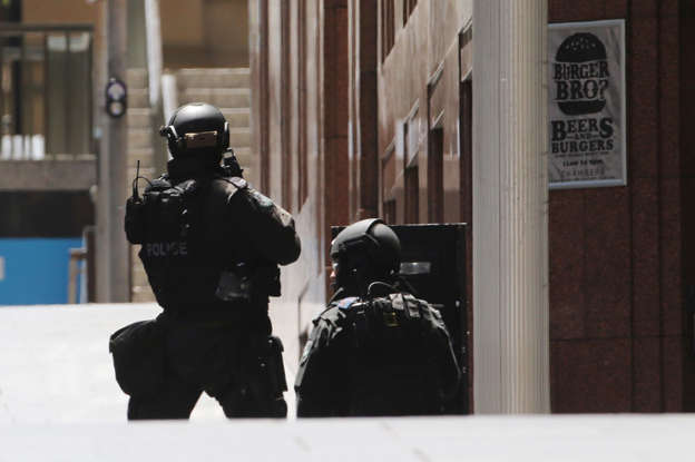 At least one gunman is holding up to 13 people hostage inside the Lindt chocolate at Martin Place in Sydney.