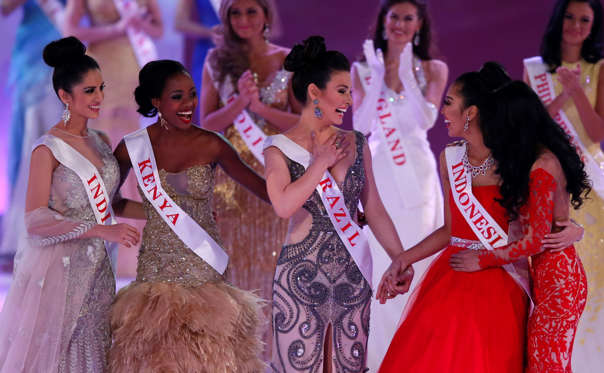 From left, Miss India Koyal Rana, Miss Kenya, Idah Nguma, Miss Brazil, Julia Gama, Miss Indonesia Maria Asteria Sastrayu Rahajeng, and Miss Malaysia, Dewi Liana Seriestha, celebrate, after winning the charity section of the Miss World competition, at the ExCel centre in London, Sunday, Dec. 14 2014.
