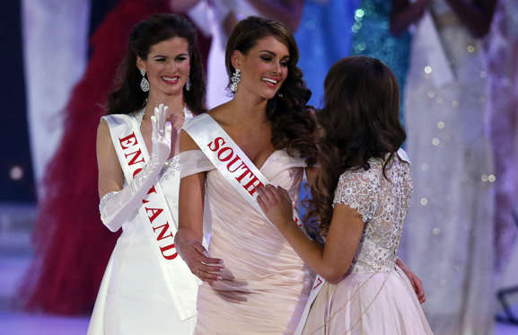 Miss South Africa Rolene Strauss, centre, reacts as she is named Miss World 2014, during the finale of the competition, at the ExCel centre in London, Sunday, Dec. 14, 2014. Miss Hungary Edina Kulcsar came second with Miss United States, Elizabeth Safrit, finishing third.