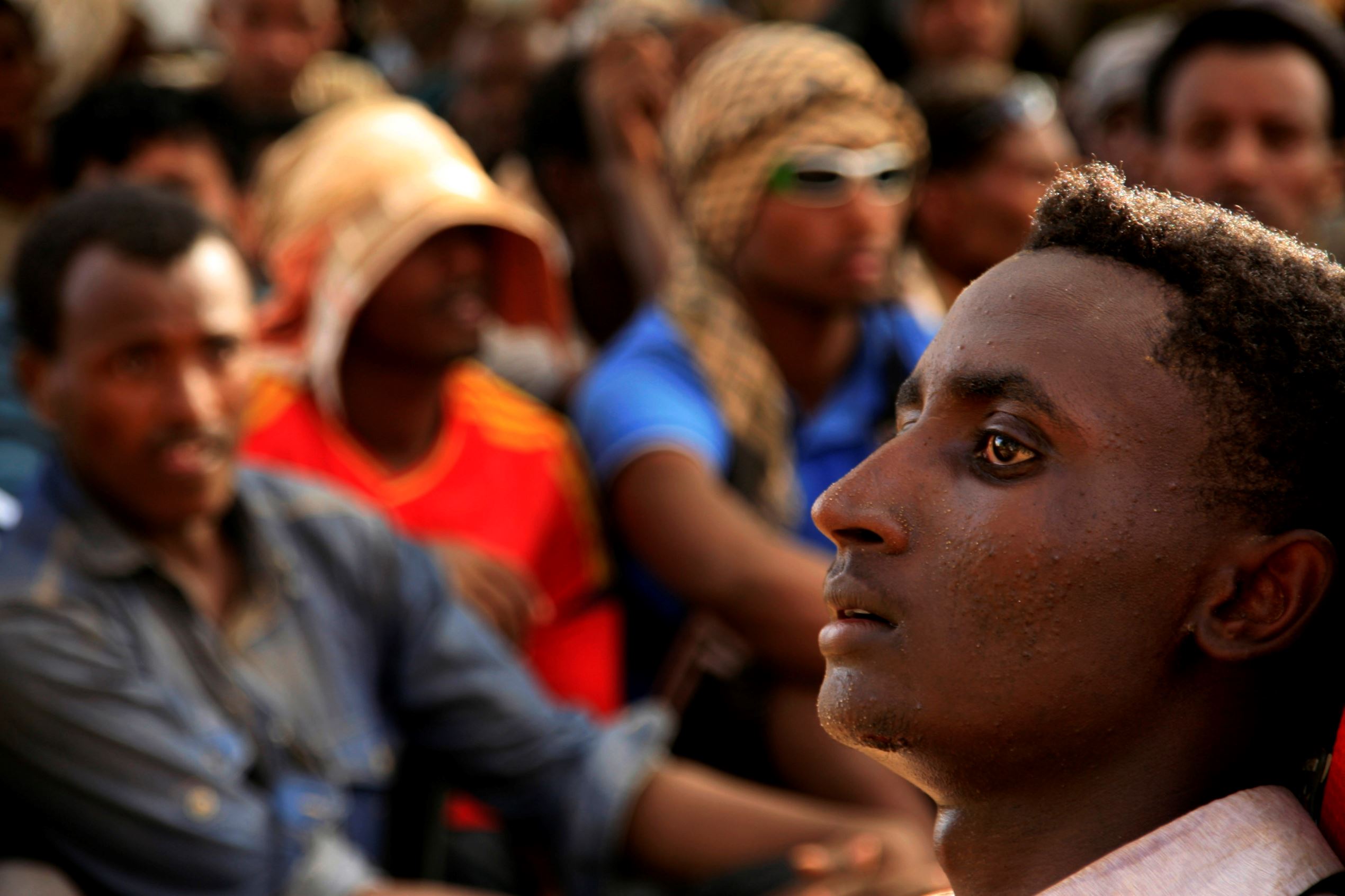 Illegal immigrants who were abandoned by traffickers in a remote desert area wait inside a military base in Dongola town in Sudan, after being located by Sudanese and Libyan forces, May 3, 2014. The desert area between Sudan and Libya is a major route for illegal immigrants trying to escape Sudan's war-torn regions, with many of them transiting in Libya before trying to flee to Europe across the Mediterranean Sea.