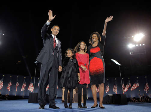 Barack Obama with his wife Michelle Obama, right, and two daughters, Sasha, Malia wave at the election night rally in Chicago.