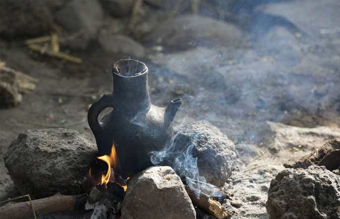 The coffee making ceremony involves roasting the beans in a container, grinding them on a wooden mortar and pestle and then brewing them in a special pottery vessel with a spherical base called jebena. The entire process can take up to 2 two hours and it is served with salt and butter instead of sugar.