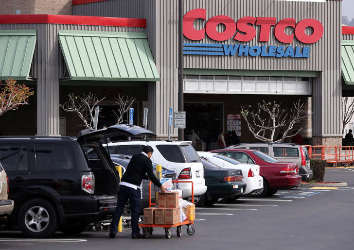 A customer packs groceries into his car outside of a Costco store on March 6, 2014, in Richmond, Calif.